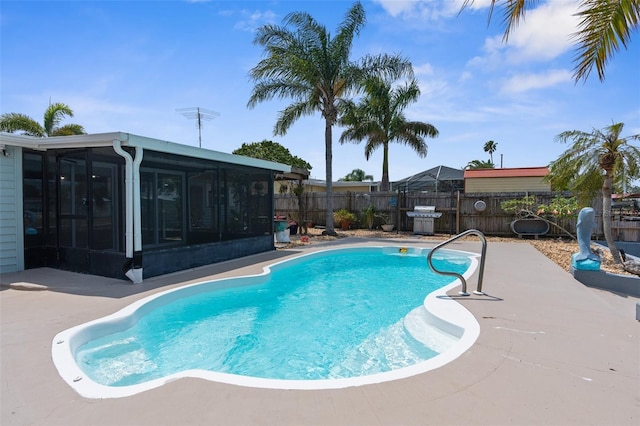 13411 Lisa Dr, Hudson, FL 34667 - view of pool with a sunroom, a fenced backyard, and a patio area