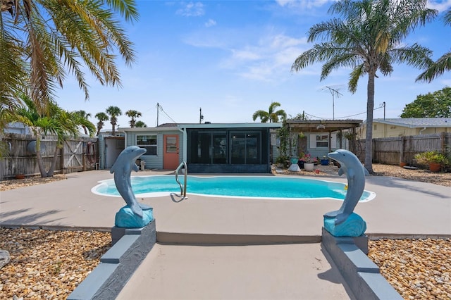 13411 Lisa Dr, Hudson, FL 34667 - view of swimming pool with a sunroom, a fenced backyard, and a patio area