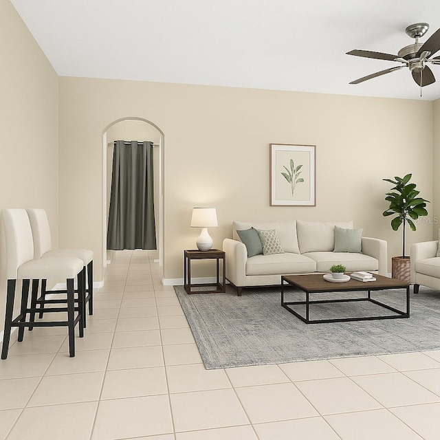 living room with light tile patterned floors, ceiling fan, and baseboards