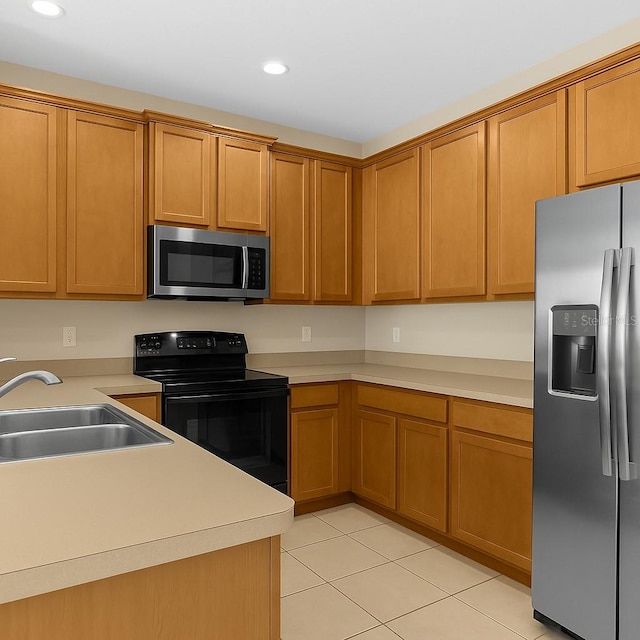 kitchen featuring appliances with stainless steel finishes, a sink, light tile patterned floors, recessed lighting, and light countertops