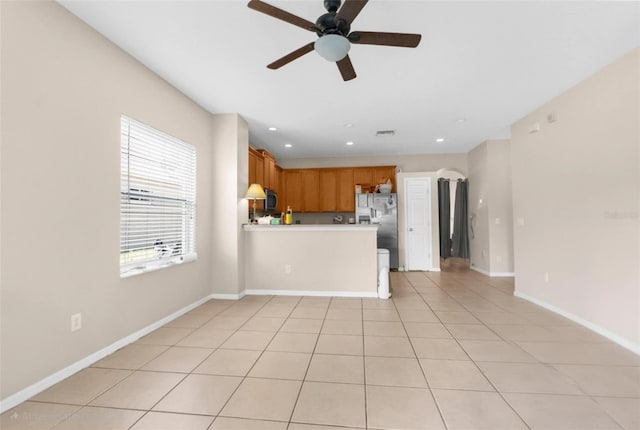 unfurnished living room featuring a ceiling fan, baseboards, recessed lighting, and light tile patterned floors