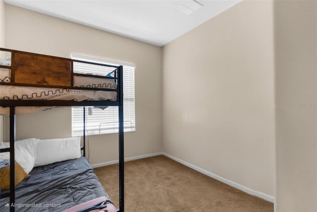 bedroom with carpet and baseboards