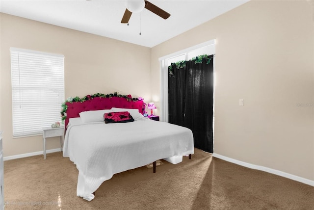 bedroom with carpet flooring, baseboards, and a ceiling fan