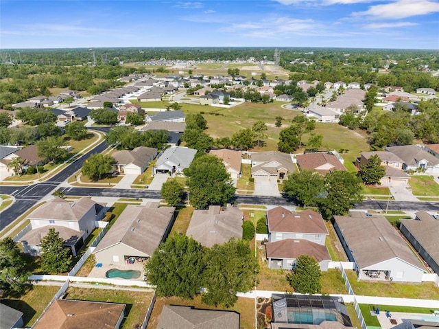 aerial overview of property's location featuring nearby suburban area and a pool