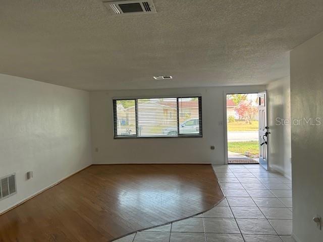 7331 Sandalwood Dr, Port Richey, FL 34668 - unfurnished room with a textured ceiling and light tile patterned flooring