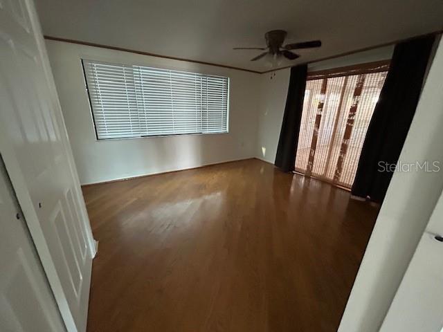 7331 Sandalwood Dr, Port Richey, FL 34668 - spare room with wood finished floors and a ceiling fan