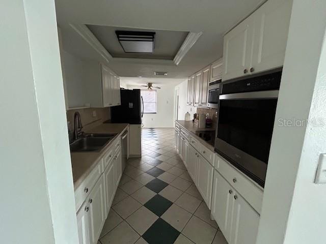 7331 Sandalwood Dr, Port Richey, FL 34668 - kitchen with a sink, appliances with stainless steel finishes, a tray ceiling, and white cabinetry