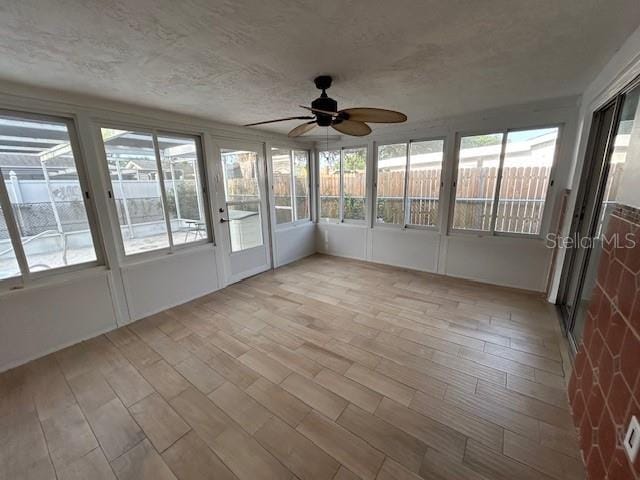 7331 Sandalwood Dr, Port Richey, FL 34668 - unfurnished sunroom with a ceiling fan and plenty of natural light