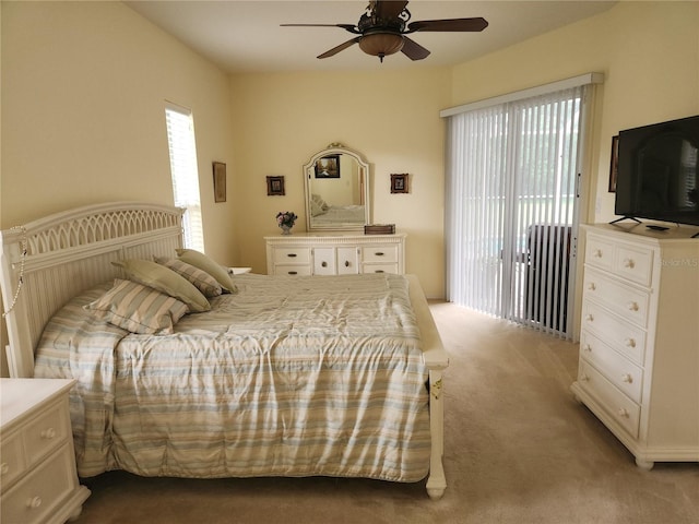 carpeted bedroom featuring access to exterior and ceiling fan