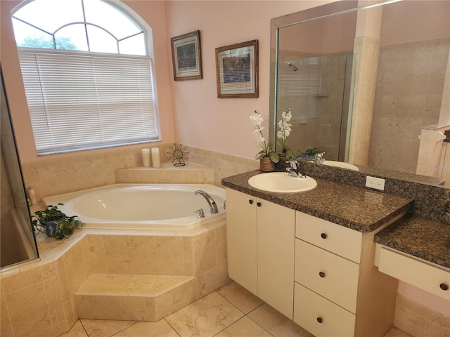 full bath with tiled shower, a garden tub, tile patterned floors, and vanity