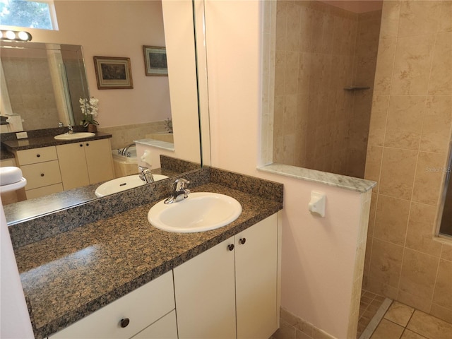 bathroom with walk in shower, two vanities, tile patterned floors, and a bath