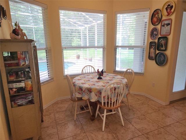 dining room with baseboards and light tile patterned floors