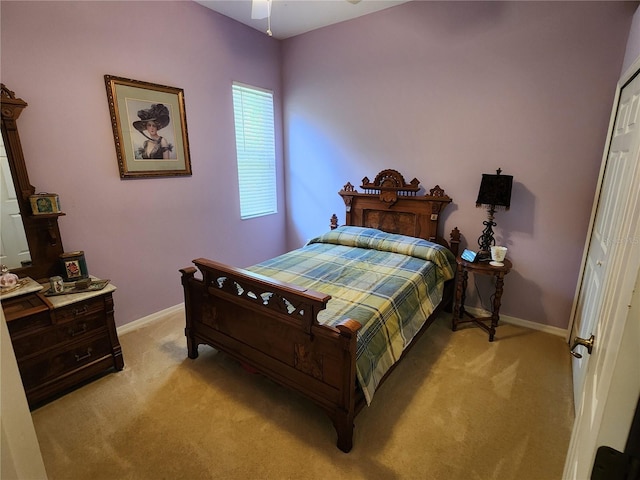 bedroom with light colored carpet, baseboards, and ceiling fan