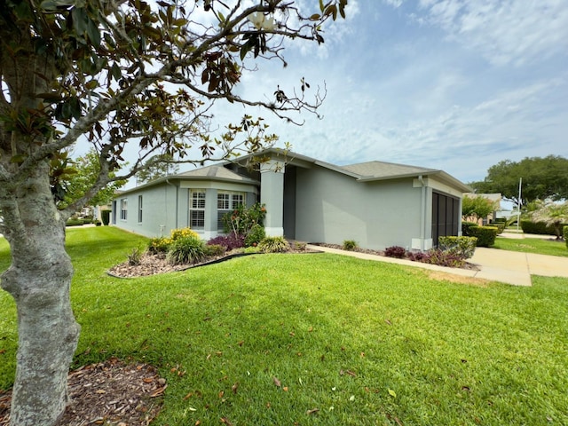 18109 Webster Grove Dr, Hudson, FL 34667 - view of front facade featuring stucco siding, a garage, a front yard, and driveway