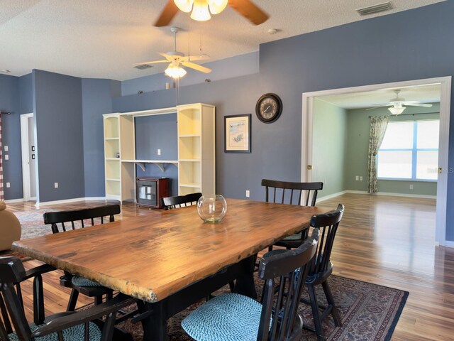 18109 Webster Grove Dr, Hudson, FL 34667 - dining room featuring ceiling fan, wood finished floors, a textured ceiling, and baseboards