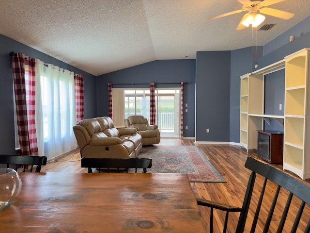 18109 Webster Grove Dr, Hudson, FL 34667 - living area with vaulted ceiling, wood finished floors, a textured ceiling, ceiling fan, and baseboards