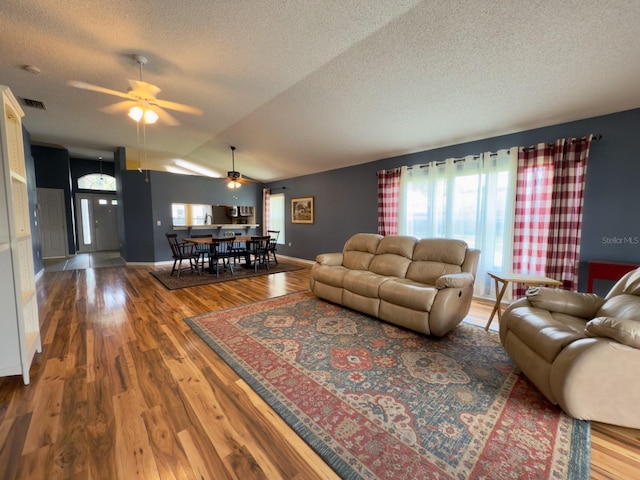 18109 Webster Grove Dr, Hudson, FL 34667 - living room featuring a textured ceiling, plenty of natural light, wood finished floors, a ceiling fan, and lofted ceiling