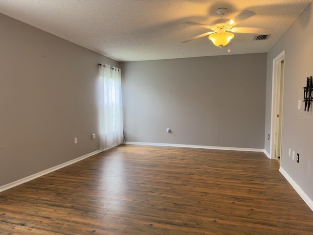 18109 Webster Grove Dr, Hudson, FL 34667 - empty room with dark wood finished floors, ceiling fan, a textured ceiling, and baseboards