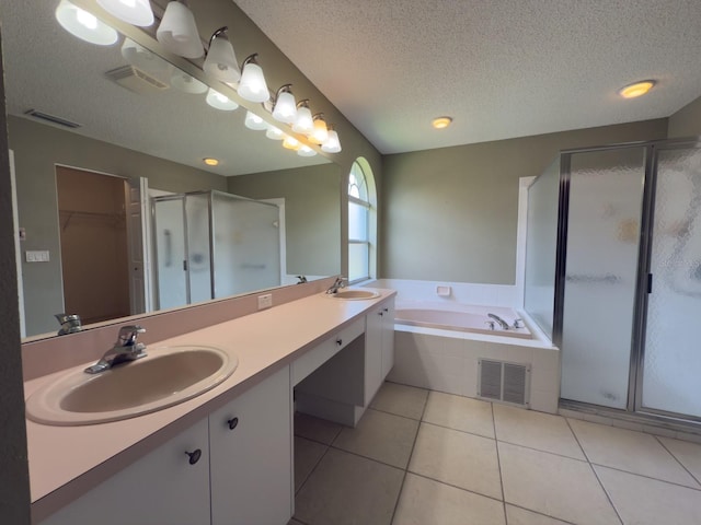 18109 Webster Grove Dr, Hudson, FL 34667 - full bathroom with a garden tub, a textured ceiling, a stall shower, double vanity, and tile patterned floors