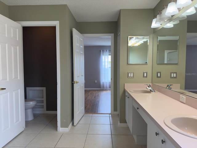 18109 Webster Grove Dr, Hudson, FL 34667 - bathroom with toilet, baseboards, tile patterned flooring, and double vanity
