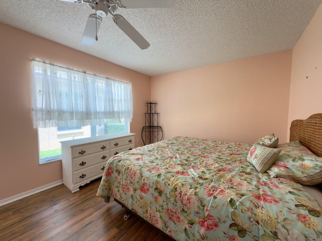 18109 Webster Grove Dr, Hudson, FL 34667 - bedroom with dark wood-style flooring, a textured ceiling, ceiling fan, and baseboards
