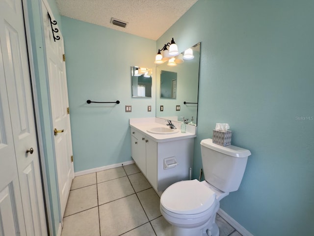 18109 Webster Grove Dr, Hudson, FL 34667 - bathroom with a textured ceiling, toilet, vanity, tile patterned flooring, and baseboards
