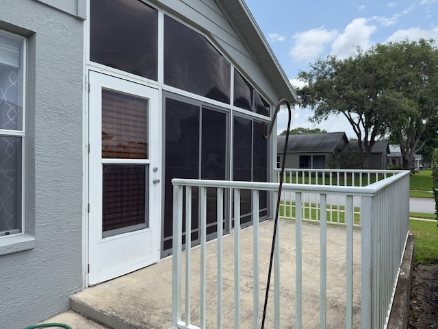 18109 Webster Grove Dr, Hudson, FL 34667 - view of home's exterior featuring stucco siding and a sunroom