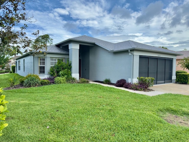 18109 Webster Grove Dr, Hudson, FL 34667 - view of front of property featuring stucco siding, an attached garage, concrete driveway, and a front yard