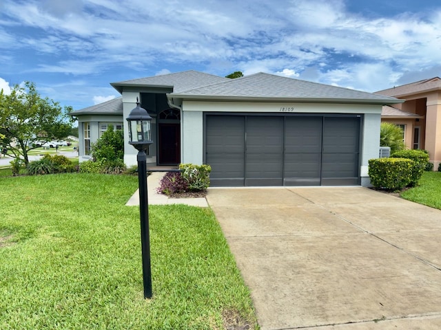 18109 Webster Grove Dr, Hudson, FL 34667 - view of front of home with an attached garage, a front yard, driveway, and stucco siding