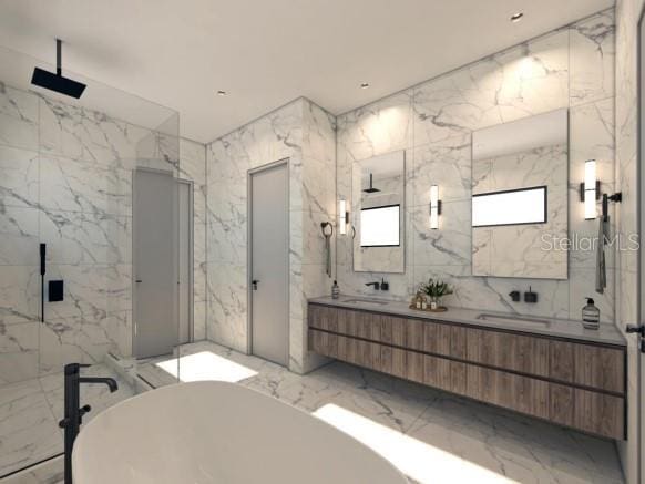 bathroom featuring marble tiled floors, a marble finish shower, a freestanding tub, and double vanity