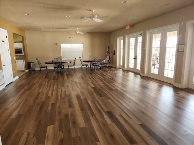 unfurnished dining area with french doors, wood finished floors, recessed lighting, baseboards, and a ceiling fan