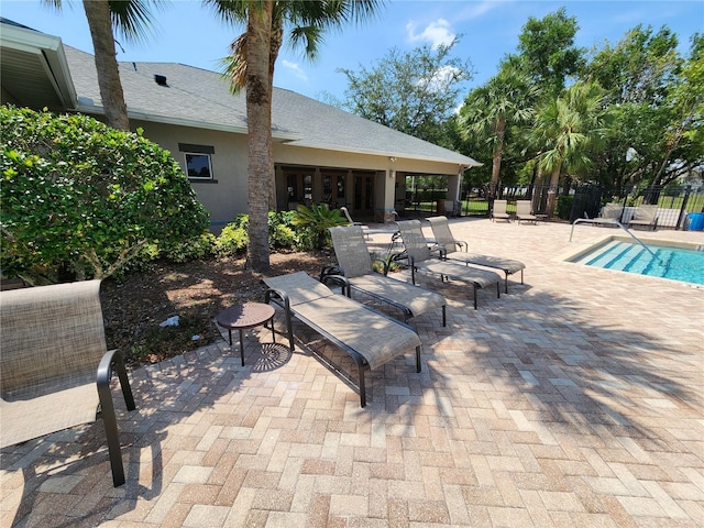 view of patio / terrace featuring fence and a community pool
