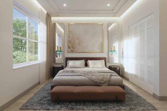 5477 Creek Ridge Rd, Brooksville, FL 34601 - bedroom featuring a tray ceiling, light wood-style flooring, baseboards, recessed lighting, and a closet