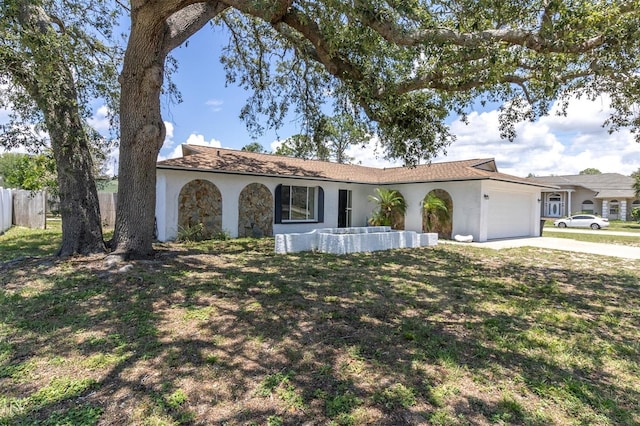 1402 Tallahassee Dr, Tarpon Springs, FL 34689 - ranch-style home with concrete driveway, a garage, and stucco siding