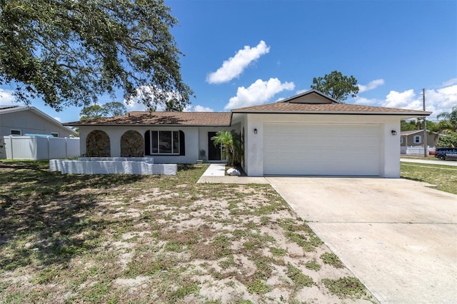 1402 Tallahassee Dr, Tarpon Springs, FL 34689 - ranch-style home featuring stucco siding, a garage, concrete driveway, and fence