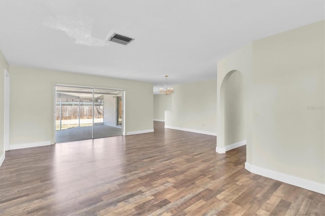 1402 Tallahassee Dr, Tarpon Springs, FL 34689 - unfurnished room with a chandelier, wood finished floors, and baseboards
