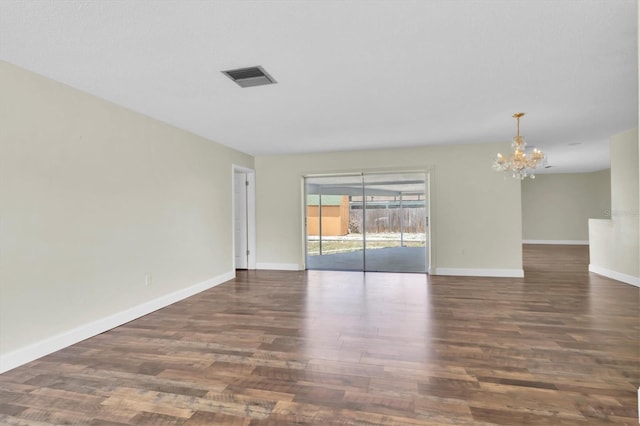 1402 Tallahassee Dr, Tarpon Springs, FL 34689 - unfurnished room featuring a chandelier, wood finished floors, and baseboards