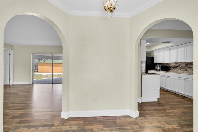1402 Tallahassee Dr, Tarpon Springs, FL 34689 - hallway with dark wood-type flooring, ornamental molding, arched walkways, and baseboards
