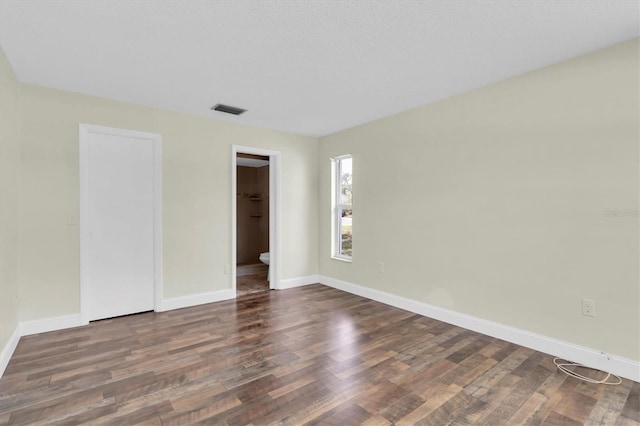 1402 Tallahassee Dr, Tarpon Springs, FL 34689 - spare room featuring wood finished floors and baseboards