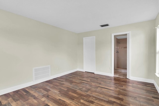 1402 Tallahassee Dr, Tarpon Springs, FL 34689 - spare room with dark wood-style floors and baseboards