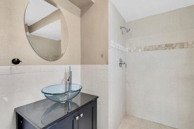 1402 Tallahassee Dr, Tarpon Springs, FL 34689 - full bath with a tile shower, vanity, tile walls, and wainscoting