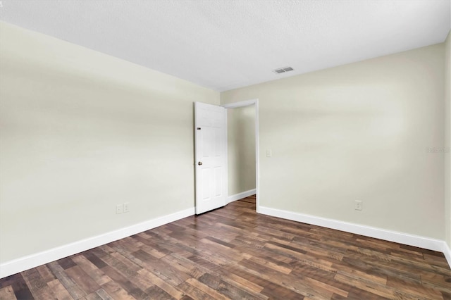 1402 Tallahassee Dr, Tarpon Springs, FL 34689 - spare room with baseboards and dark wood-type flooring