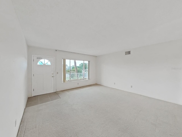 foyer featuring light carpet