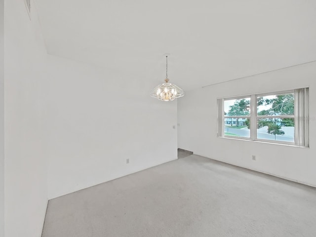 spare room with a chandelier