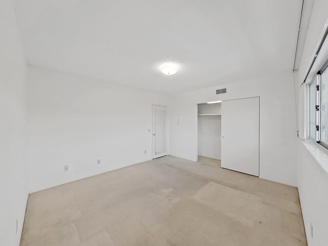 unfurnished bedroom with light colored carpet