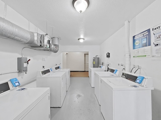 community laundry featuring washer and clothes dryer, electric water heater, a textured ceiling, and electric panel