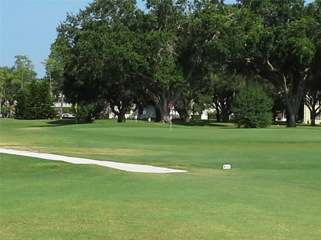 view of property's community featuring a yard and golf course view