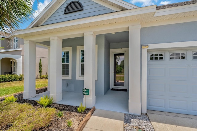 11401 Quiet Forest Dr, Tampa, FL 33635 - view of exterior entry with covered porch, stucco siding, and an attached garage