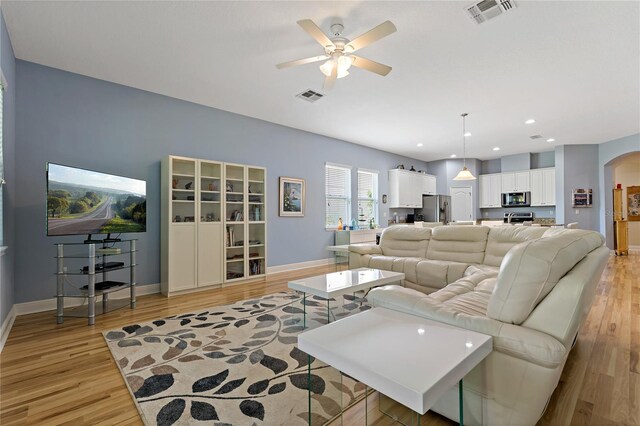 11401 Quiet Forest Dr, Tampa, FL 33635 - living area with arched walkways, a ceiling fan, baseboards, light wood finished floors, and recessed lighting