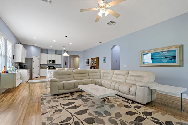 11401 Quiet Forest Dr, Tampa, FL 33635 - living area featuring arched walkways, light wood-style flooring, a ceiling fan, and recessed lighting